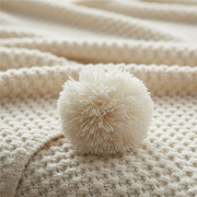 Scandinavian Waffle Knit Throw Blanket with Playful Pom Pom Tassels