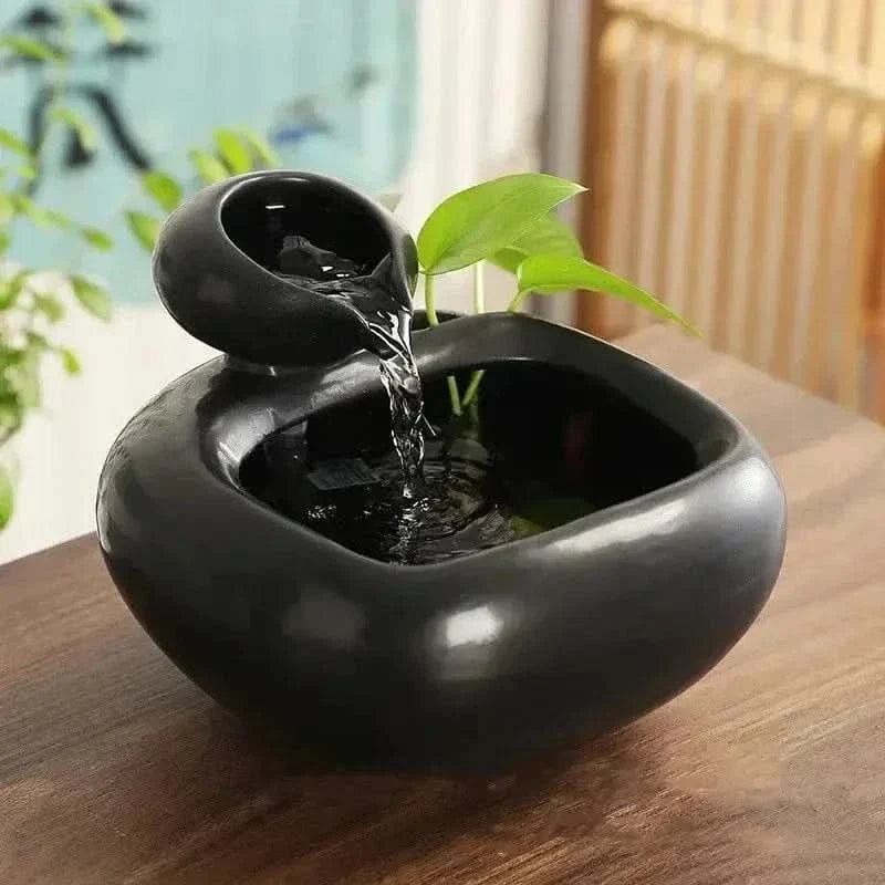 Cat drinking from the ceramic water fountain